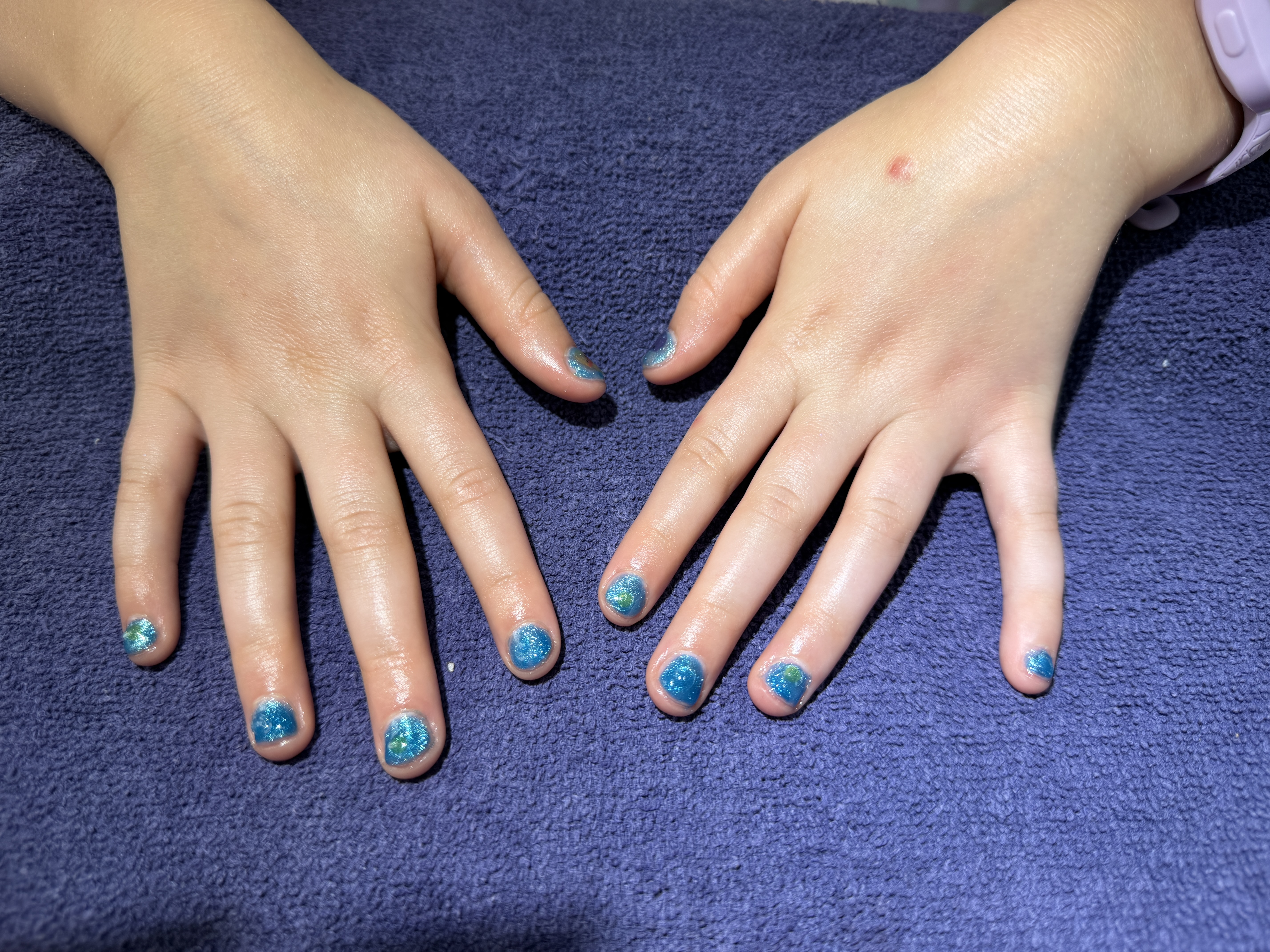 Young client’s blue and turquoise glitter manicure