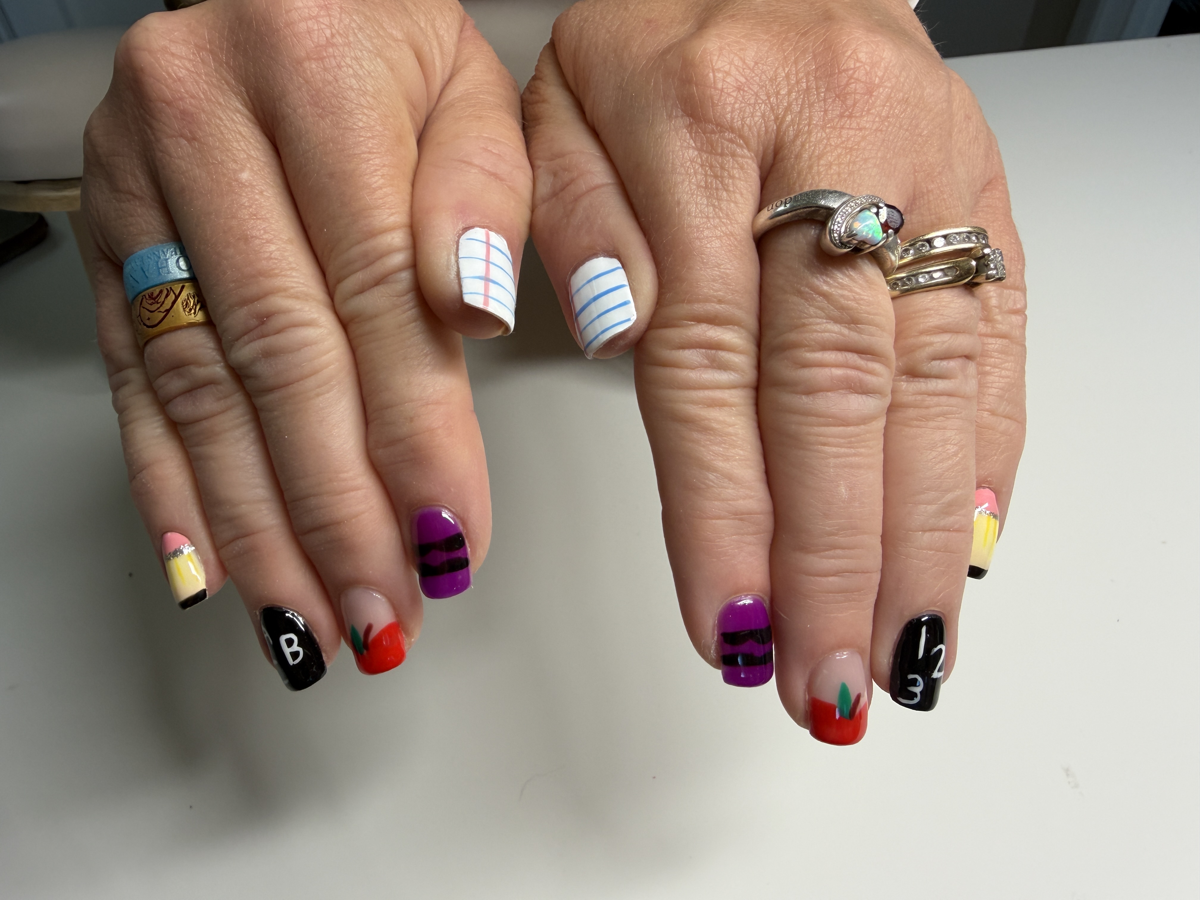 Colorful manicure with striped accent nails
